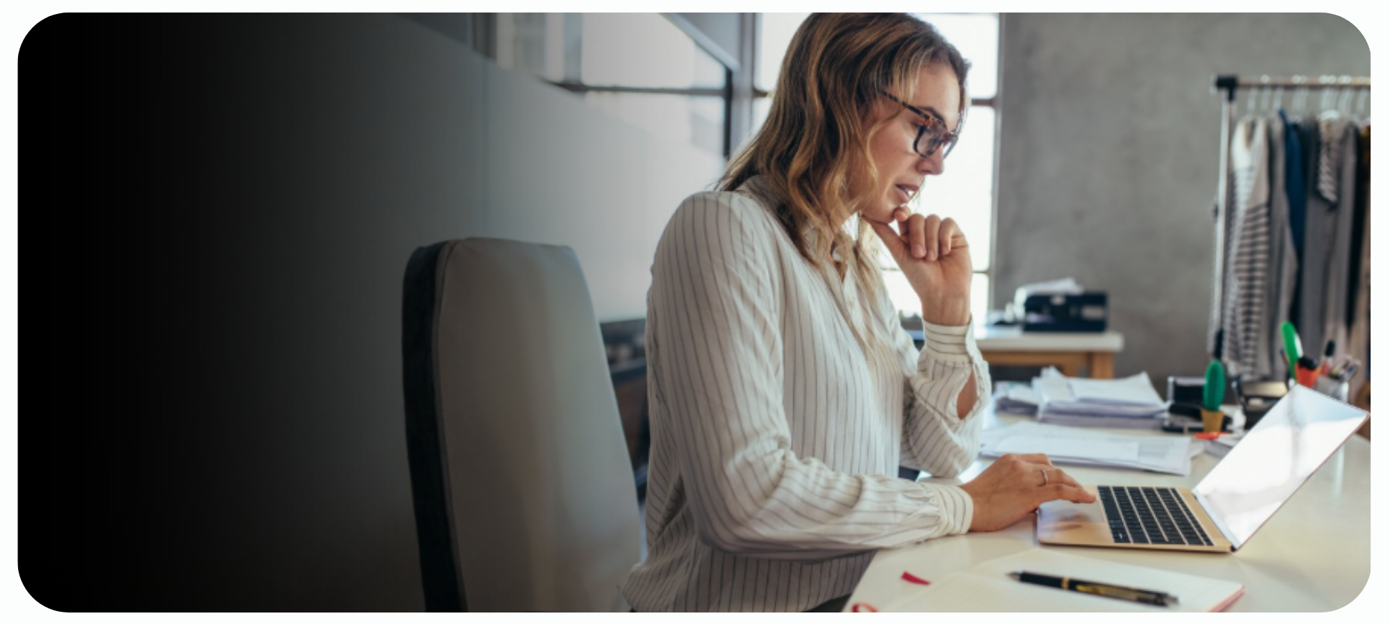Woman working at computer reviewing cyber security risk